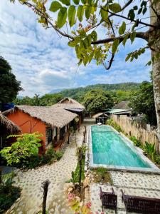 a view of a resort with a swimming pool at Mai Chau Tropical Homestay in Hòa Bình