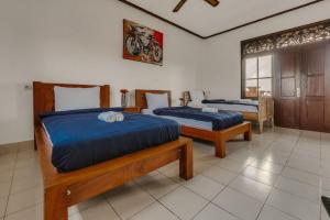 Postel nebo postele na pokoji v ubytování Ubud Backpacker Hostel