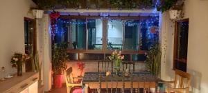 a table in a room with a window with christmas lights at Guest house. Shared room in panoramic apartment. Private bathroom. Kitchen and washmachine in Huaraz