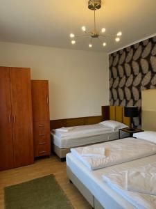 Posteľ alebo postele v izbe v ubytovaní Y Apartman