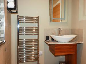 a bathroom with a sink and a mirror at Demelza in St Austell