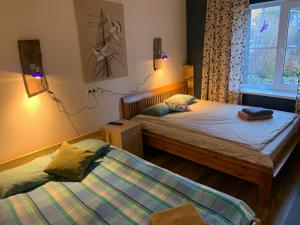 a bedroom with two twin beds and a window at Delta11 - 2 bedrooms, 2 big beds, 1 single bed in Tartu