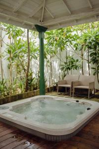 a hot tub in a room with plants at Villa Sayura by TONIK, Boossa - Beachfront in Busse +36 photos