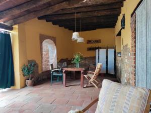 a patio with a table and chairs in a room at La Siesta VTAR in El Alcornocal