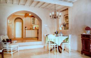 a dining room with a white table and chairs at Bioagriturismo Podere Montisi in Calenzano