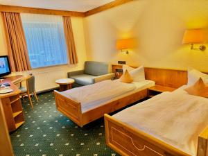 Postel nebo postele na pokoji v ubytování Hotel Simonshof