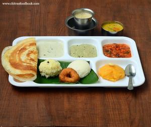 a tray of food with bread and other foods on a table at Divine Beach Resorts in Pondicherry