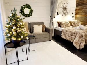 a living room with a christmas tree and a couch at Apartment Suutarintie - Authentic Lappish experience by the River in Rovaniemi +32 photos