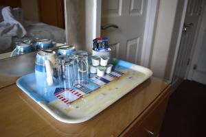 a tray on a counter with bottles on it at Harrington Guest House in Newquay