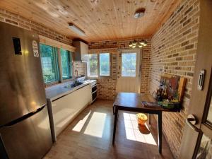 a kitchen with a stainless steel refrigerator and a table at Executive Home in Jeju in Jeju