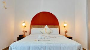 a bedroom with a white bed with a red headboard at 1BR Apartment in Yas Island with Private Balcony in Abu Dhabi