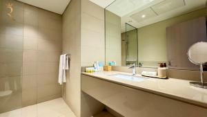 a bathroom with a sink and a mirror at 1BR Apartment in Yas Island with Private Balcony in Abu Dhabi