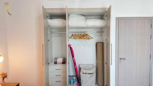 a walk in closet with white shelves and a door at 1BR Apartment in Yas Island with Private Balcony in Abu Dhabi