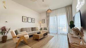 a living room with a couch and a table at 1BR Apartment in Yas Island with Private Balcony in Abu Dhabi