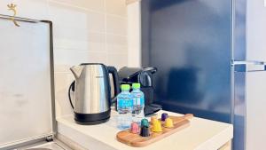 a counter with bottles of water and a coffee maker at 1BR Apartment in Yas Island with Private Balcony in Abu Dhabi