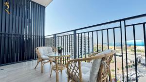 a balcony with chairs and a table and a view of the ocean at 1BR Apartment in Yas Island with Private Balcony in Abu Dhabi