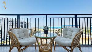 two chairs and a glass table on a balcony at 1BR Apartment in Yas Island with Private Balcony in Abu Dhabi