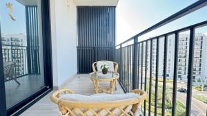 a balcony with two chairs and a table at 1BR Apartment in Yas Island with Private Balcony in Abu Dhabi