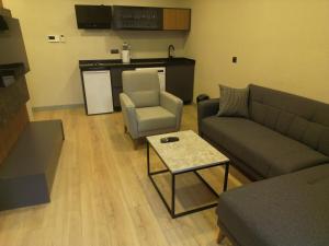 a living room with a couch and a table at Questa Deluxe Hotel in Trabzon