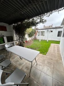 a white table and chairs on a patio at La Casita de Salta 421 in Concordia