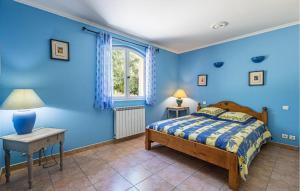 una camera blu con un letto e un tavolo di Cozy Home In Peymeinade a Peymeinade Altre 7 foto
