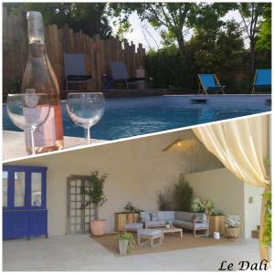 Una botella de vino y una copa junto a una piscina en Maison paisible Le Dali, en Piolenc