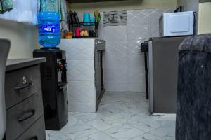 a kitchen with a water bottle on top of a counter at Tala Cosy Homes in Tawa +2 photos