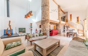 a living room with couches and a table at Awesome Home In Pardailhan With Kitchen in Pardailhan