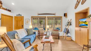 a living room with a blue couch and a table at Rager Mountain - Unit 10 in Sunriver