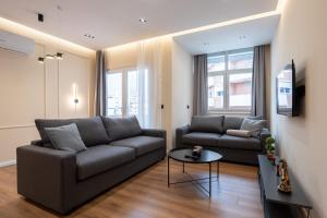 a living room with a couch and a table at Garden lake City Center New Bazar Tirana in Tirana