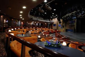 a restaurant with tables and chairs with flowers on them at Perla, Resort & Entertainment in Nova Gorica