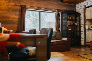 a living room with a couch and a window at Lake House in Izvoru Mureşului +24 photos