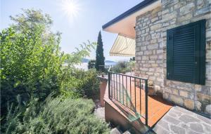 a stone house with a balcony and a door at Villa Liselote in Gargnano +13 photos