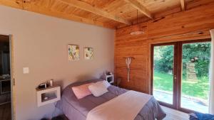 a bedroom with a bed in a room with a window at El Silencio, Lozano - Jujuy in Lozano