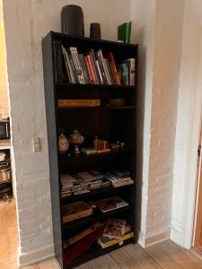 a black book shelf filled with books at City House in Odense