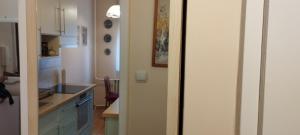 a kitchen with a white refrigerator and a counter at Rózsa lakás in Keszthely +22 photos