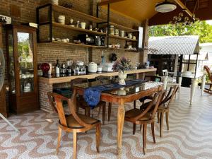 a dining room with a wooden table and chairs at Cozy breezing countryside Pet in Ban Khlong Sip Sam Lang