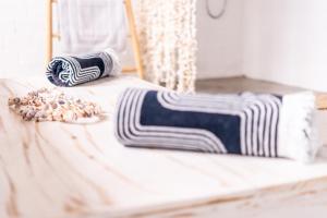 a bed with two pillows on top of it at Sunrise Beach House in St Helena Bay