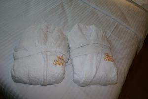 a pair of white shoes sitting on top of a bed at Guest House Savane in Gori