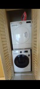 a washing machine with a sink on top of it at KUCHING StayAt Somerset Gateway 2 Room Apartment in Kuching