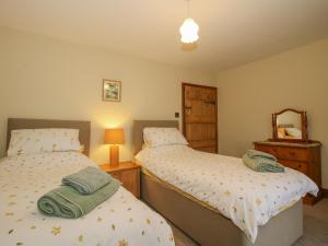 En eller flere senge i et værelse på Rowan Cottage