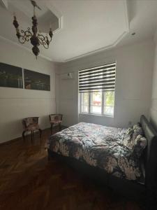 a bedroom with a bed and a window at Apartman Car new on booking in Odžaci