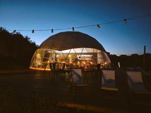 a large domed building with tables and chairs in it at Domos Park in Mar de las Pampas