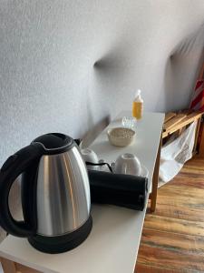 a tea kettle sitting on a table with a plate at Domos Park in Mar de las Pampas