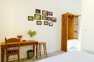a room with a desk and a chair and pictures on the wall at Phú Yên Blue Sea Villas in Phú Hiệp +6 photos