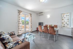 a living room with a couch and a table at Moenia Apartments in Milna