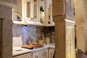 a kitchen with white cabinets and a sink at Typique maison in Dar Mimoun Bey +14 photos