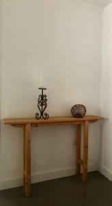 a wooden table with a vase on top of it at Dimora Storica Silver Room in Ruviano