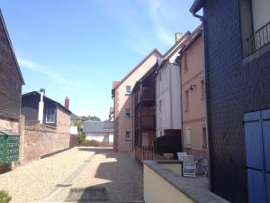 een steegje tussen twee bakstenen gebouwen bij Aux Cottages du port Honfleur in Honfleur