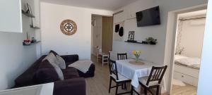 a living room with a couch and a table with chairs at Apartman Kozarčeva in Varaždin